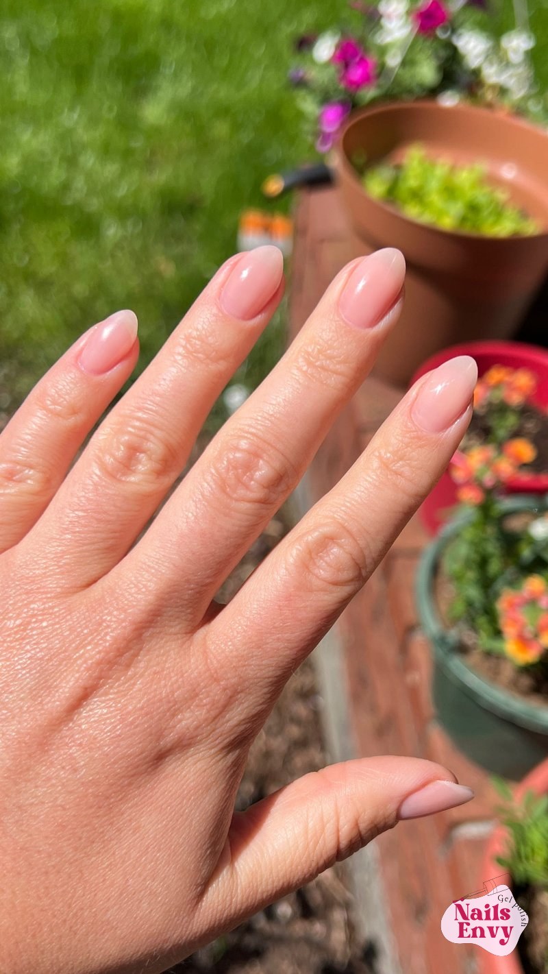 A close-up of a hand showcasing a manicure done with new Korean gel nail products, highlighting the vibrant colors and smooth finish.