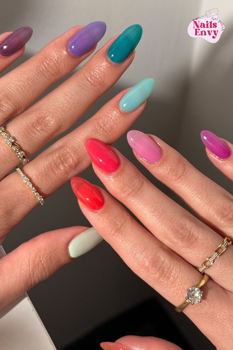 A close-up of hands displaying the April's Juiciest Nail Trend: Korean Jelly Nails, showcasing a translucent, vibrant look.